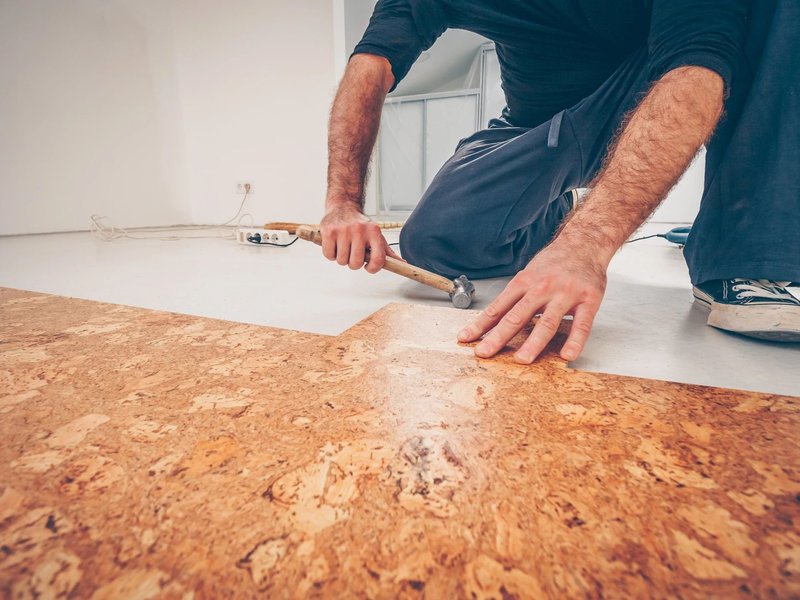 person installing cork floors - Carpet World of Martinsburg in WV